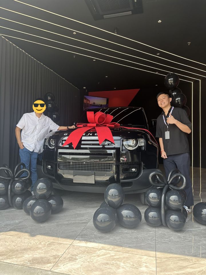 Customer handover with a red bow at D'Concept