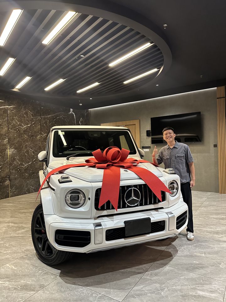 White Mercedes-Benz G-Class handover with a red bow