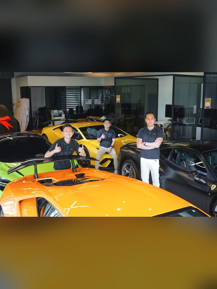 Eden and the D'Concept team with supercars in the showroom